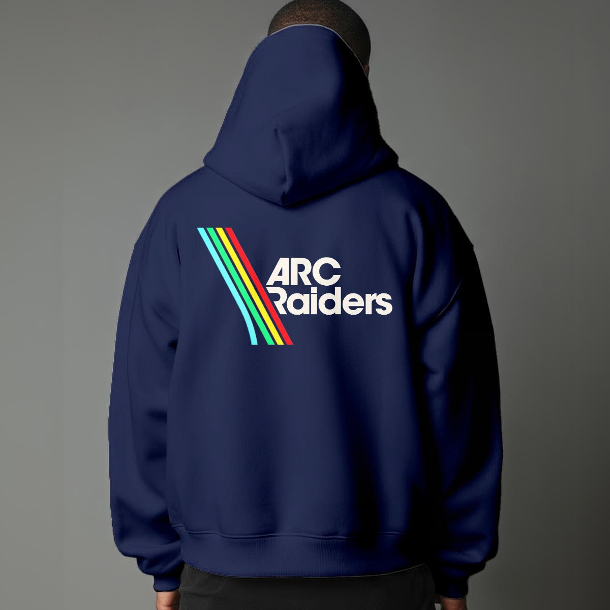 Person wearing a navy hoodie with 'ARC Raiders' logo on the back against a gray background