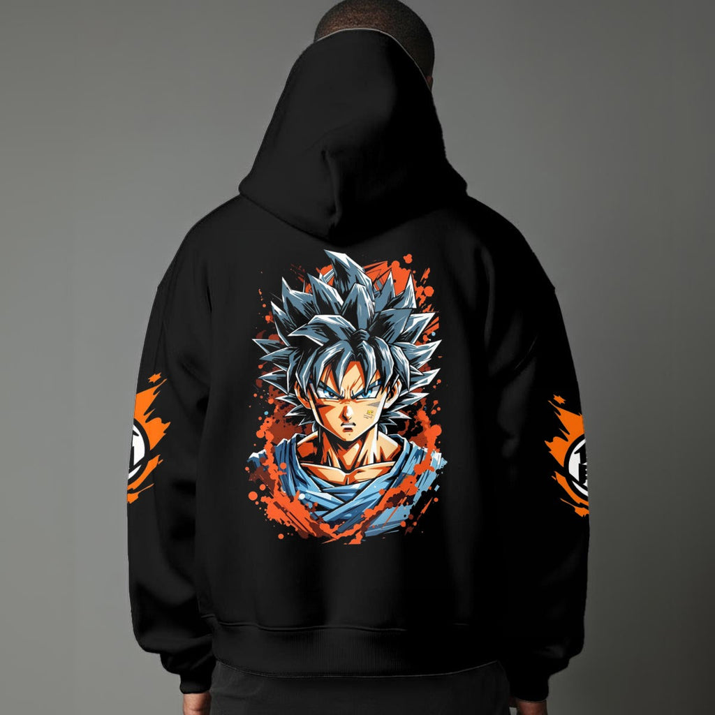 Black pullover hoodie with orange Goku silhouette on chest and vintage 1984 Dragon Ball graphics on sleeves, worn by model on grey background.