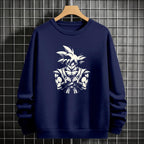 Black crewneck sweatshirt featuring Goku shadow silhouette with blue and pink neon aura and vertical Japanese text, flat lay on grey background.
